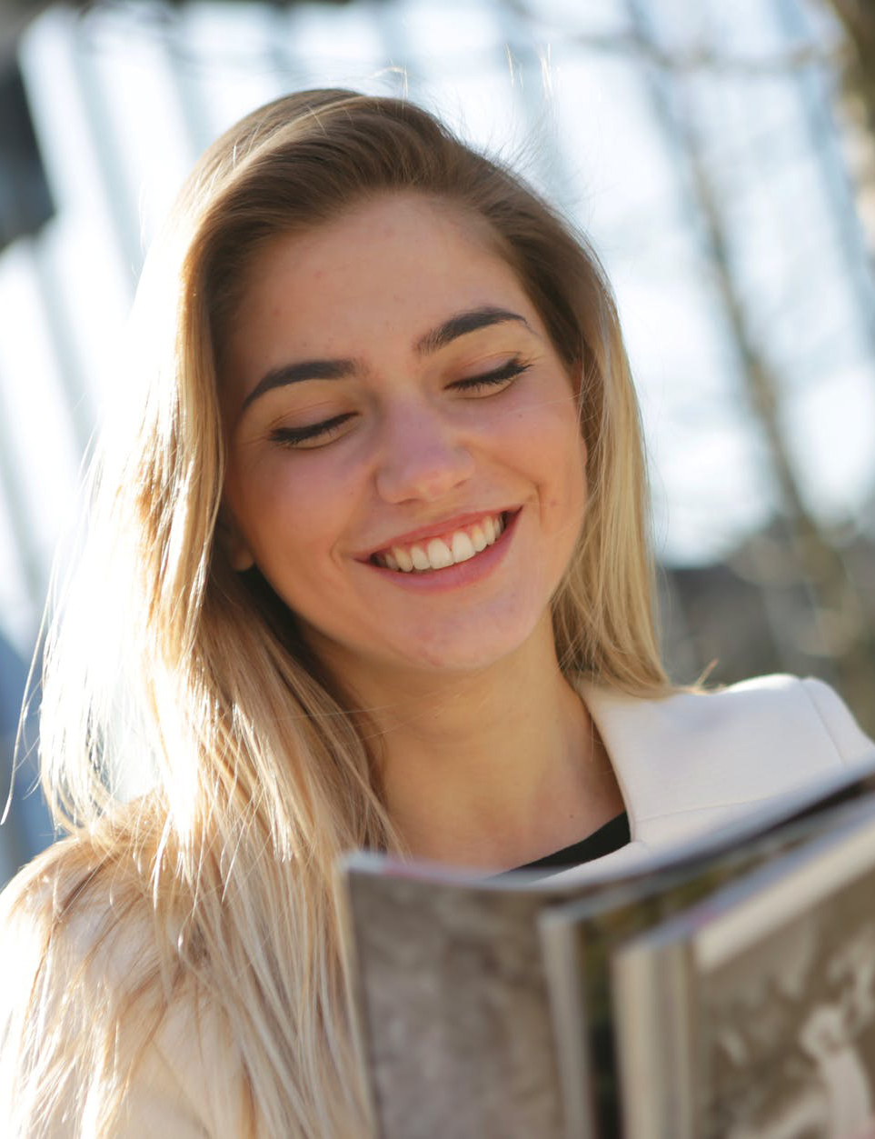 woman holding book smiling
