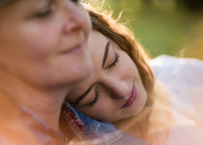 family Daughter with head on the shoulder of her mom